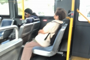 Image of dipshit taking up two bus seats